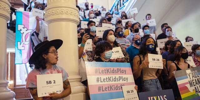 LGBTQ rights supporters gather at the Texas State Capitol to protest state Republican-led efforts to pass legislation that would restrict the participation of transgender student athletes on Sept. 20, 2021, in Austin, Texas.