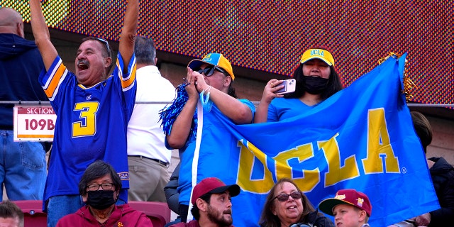 UCLA Bruins fans cheer at the Los Angeles Memorial Coliseum in Los Angeles on Nov. 20, 2021.