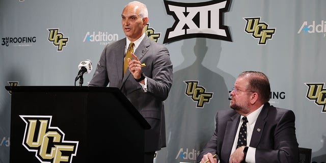 Terry Mohajir, UCF vice president and director of athletics, speaks as UCF President Alexander N. Cartwright looks on during a news conference to announce UCF is joining the Big 12 Conference. 