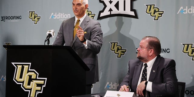 Terry Mohajir, UCF vice president and director of athletics, speaks as UCF President Alexander N. Cartwright looks on during a news conference to announce UCF is joining the Big 12 Conference.