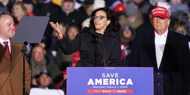 Republican House of Representative candidates Katie Arrington, center, and Russell Fry, left, join former President Donald Trump, right, at a rally on March 12, 2022 in Florence, South Carolina.