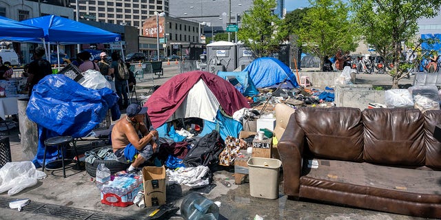 People at a homeless encampment in Toriumi Plaza at 1st St and Judge John Aiso St in Los Angeles Thursday, March 17, 2022. 