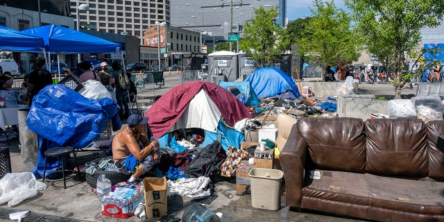 People at a homeless encampment in Toriumi Plaza at 1st St and Judge John Aiso St in Los Angeles Thursday, March 17, 2022. 