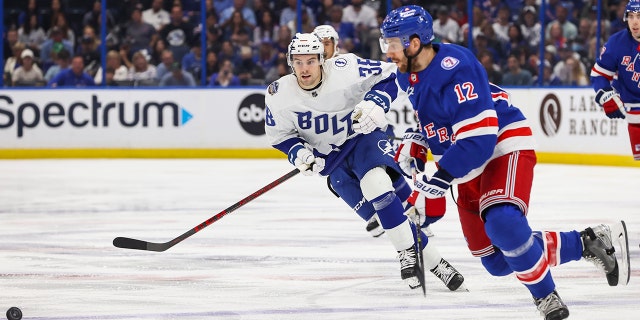 Brandon Hagel #38 of the Tampa Bay Lightning skates against Patrik Nemeth #12 of the New York Rangers during the first period at Amalie Arena on March 19.