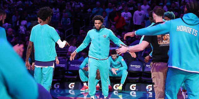 Miles Bridges #0 of the Charlotte Hornets walks onto the court before the game against the Washington Wizards on April 10, 2022 at Spectrum Center in Charlotte, North Carolina. 
