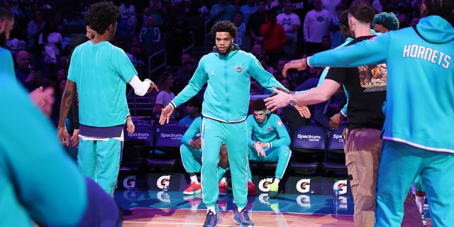 Miles Bridges, #0 of the Charlotte Hornets, walks onto the court before the game against the Washington Wizards on April 10, 2022 at Spectrum Center in Charlotte, North Carolina. 