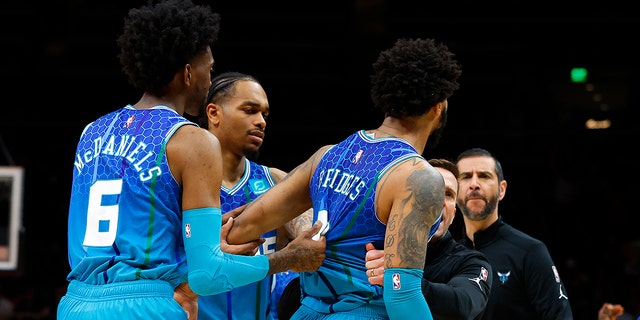 The Charlotte Hornets' Miles Bridge #0 is stopped after being called a foul and kicked out during the second half against the Atlanta Hawks at State Farm Arena on April 13, 2022 in Atlanta, Georgia. 