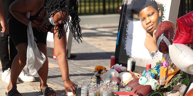 Family members and friends of Tyre Sampson leave items during a vigil in front of the Orlando Free Fall ride in ICON Park in Orlando on Monday, March 28, 2022. 