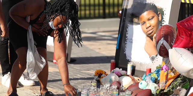 Family members and friends of Tyre Sampson leave items during a vigil in front of the Orlando Free Fall ride in ICON Park in Orlando on Monday, March 28, 2022. 