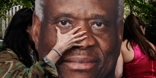 Demonstrators with a sign of U.S. Supreme Court Justice Clarence Thomas during an abortion-rights protest.