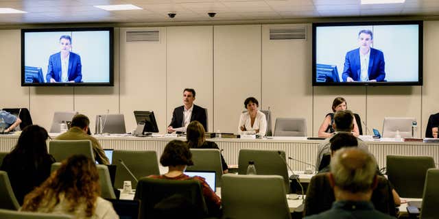 Grenoble mayor Eric Piolle (L), of the French ecologist party EELV, next to his first deputy Elisa Martin (C), chairs a city council session set to scrap its bathing dress code in municipal pools and by so authorising the wearing of the "burkini" all-in-one swimsuit for women, on May 16, 2022 in Grenoble. (Photo by JEFF PACHOUD/AFP via Getty Images)