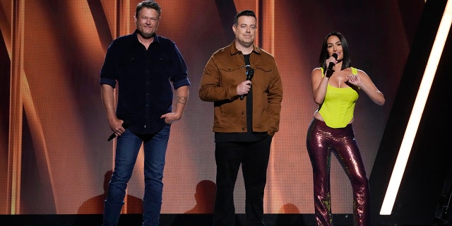 2022 NBCUniversal Upfront in New York City on Monday, May 16, 2022 -- Pictured: (l-r) Blake Shelton, Carson Daly, Nikki Bella.