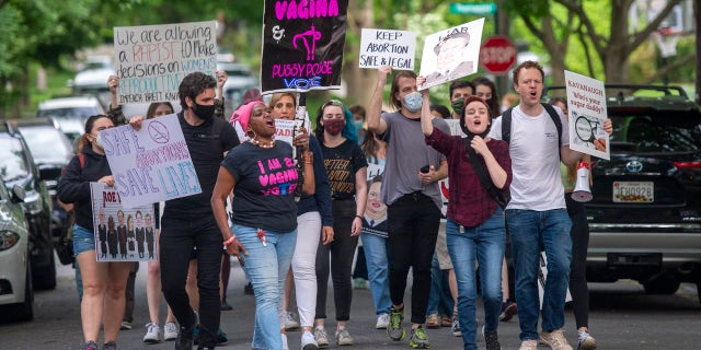 Pro-choice activists approach the home of U.S. Supreme Court Justice Brett Kavanaugh in Chevy Chase, Maryland.