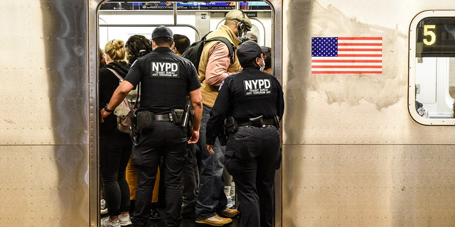 New York Police Department (NYPD) Transit officers enter a subway at a station in New York, Wednesday, May 25, 2022. 