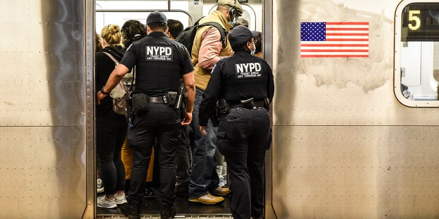 New York Police Department (NYPD) Transit officers enter a subway at a station in New York, Wednesday, May 25, 2022.