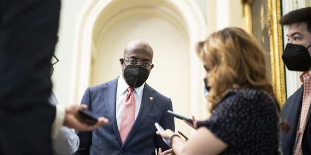 Sen. Raphael Warnock speaks with reporters before a Democratic policy luncheon on Capitol Hill, Dec. 17, 2021.
