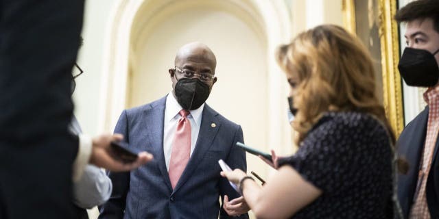 Sen. Raphael Warnock speaks with reporters before a Democratic policy luncheon on Capitol Hill, Dec. 17, 2021.