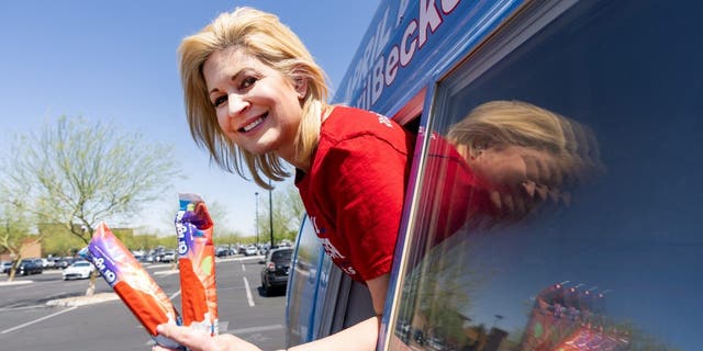 Republican candidate for US Congress April Becker poses in the window of her campaign van, a converted ice cream truck, in Las Vegas, Nev.  on Sunday, May 29, 2022.
