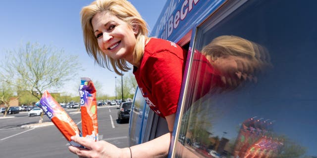 GOP Republican nominee April Becker poses in front of the window of a campaign van converted from an ice cream truck in Las Vegas on Sunday, May 29, 2022.