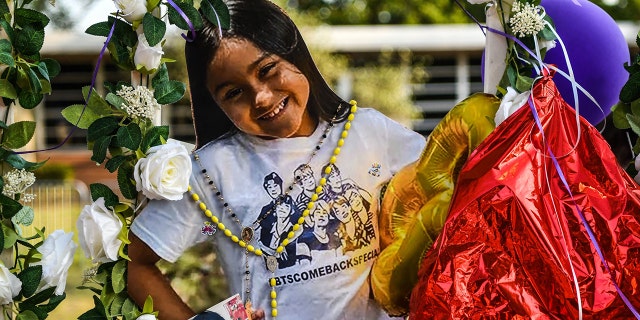 Photo of Amerie Jo Garza, 10, who died in the Texas school shooting, is placed at a makeshift memorial at Robb Elementary School in Uvalde, Texas, on May 30, 2022. (Photo by CHANDAN KHANNA/AFP via Getty Images)