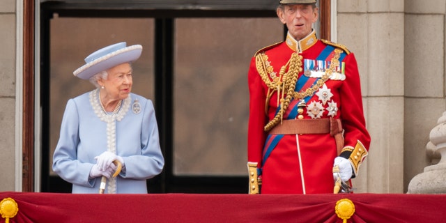 Queen Elizabeth and Prince Edward, Duke of Kent, watch the Queen's birthday parade from Buckingham Palace.