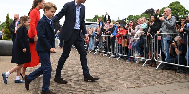 The Duke and Duchess of Cambridge and their children speak to well wishers during a visit to Cardiff Castle in Wales.