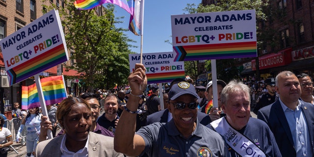 New York City Mayor Eric Adams waves a pride flag duringthe 30th annual Queens Pride Parade and Multicultural Festival in Queens, New York on June 5, 2022. 