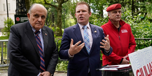 New York gubernatorial candidate Andrew Giuliani (C), with his father and former New York Mayor Rudy Giuliani (L) and Guardian Angels founder Curtis Sliwa, outlines plan to recall 'soft-on-crime' district attorneys, at City Hall Park in New York, on June 7, 2022.