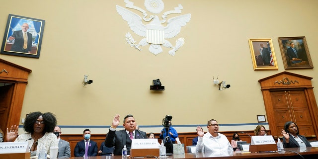 From left, Zeneta Everhart, whose son Zaire Goodman, 20, was shot in the neck during the Buffalo Tops supermarket mass shooting and survived, Roy Guerrero, a pediatrician from Uvalde, Texas, Miguel Cerrillo, father of Miah Cerrillo fourth grade student at Robb Elementary School in Uvalde, and Lucretia Hughes, of DC Project, Women for Gun Rights, are sworn in to testify during a House Committee on Oversight and Reform hearing in Washington, DC, on June 8, 2022. 