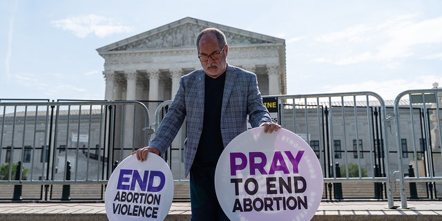 A pro-life protester prays near the US Supreme Court on Wednesday, June 8, 2022 in Washington, DC, US. 