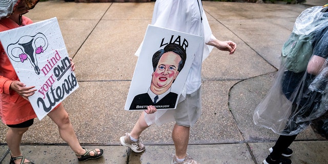 CHEVY CHASE, MD - JUNE 08: Protesters march past Supreme Court Justice Brett Kavanaugh's home on June 8, 2022 in Chevy Chase, Maryland. An armed man was arrested near Kavanaugh's home Wednesday morning as the court prepares to announce decisions for about 30 cases. 