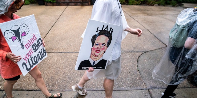 CHEVY CHASE, MD - JUNE 08: Protesters march past Supreme Court Justice Brett Kavanaugh's home on June 8, 2022 in Chevy Chase, Maryland. An armed man was arrested near Kavanaugh's home Wednesday morning as the court prepares to announce decisions for about 30 cases. 