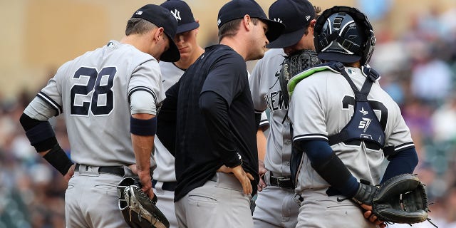 Matt Blake of the New York Yankees talks to Gerrit Cole and the rest of the infield after Cole gave up three solo home runs in a row against the Twins at Target Field on June 9, 2022, in Minneapolis, Minnesota.