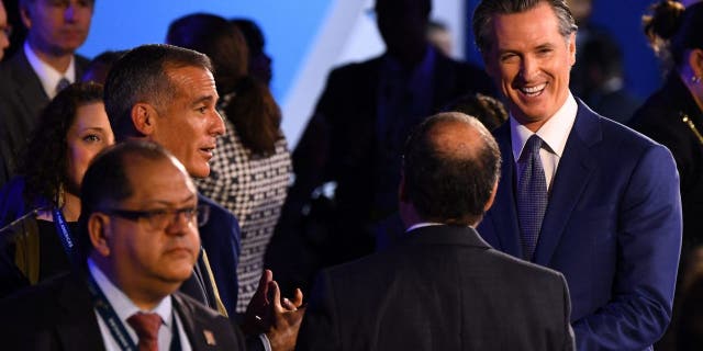 Los Angeles Mayor Eric Garcetti (2nd L) speaks to California Governor Gavin Newsom (R) ahead of a plenary session during the 9th Summit of the Americas in Los Angeles, California, June 9, 2022.