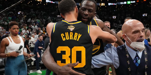 Stephen Curry (30) of the Golden State Warriors embraces teammate Draymond Green after Game 4 of the 2022 NBA Finals June 10, 2022, at TD Garden in Boston. 