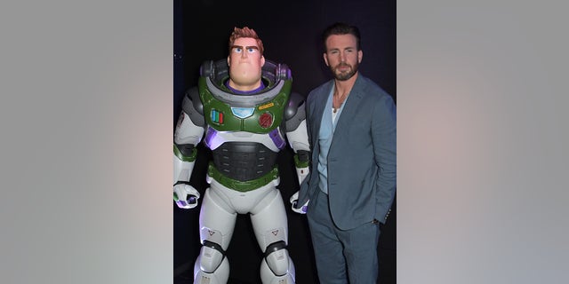 Chris Evans poses with Buzz Lightyear at the U.K. premiere of "Lightyear."