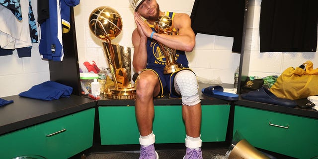 Stephen Curry, #30 of the Golden State Warriors, celebrates with the Bill Russell NBA Finals MVP Award after Game Six of the 2022 NBA Finals on June 16, 2022, at TD Garden in Boston. 