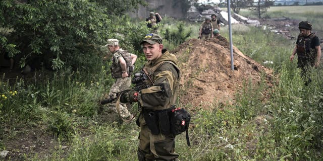 Ukrainian soldiers after a strike on June 17, 2022 at a warehouse on the outskirts of Lysychans'k in the eastern part of Ukraine in Donbus.