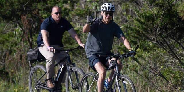 US President Joe Biden rides his bicycle at Gordon's Pond State Park in Rehoboth Beach, Delaware, on June 18, 2022. - Biden took a tumble as he was riding his bicycle Saturday morning, but was unhurt. 