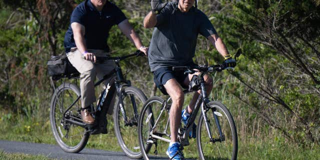 US President Joe Biden rides his bicycle at Gordon's Pond State Park in Rehoboth Beach, Delaware, on June 18, 2022. - Biden took a tumble as he was riding his bicycle Saturday morning, but was unhurt. 