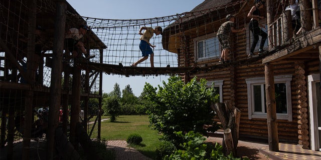 Children play in the rope park on June 20, 2022 near Kyiv, Ukraine. 