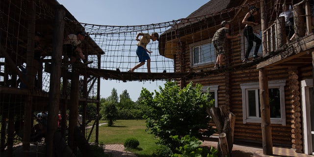 Children play in the rope park on June 20, 2022 'Diventando rosso, Ucraina.