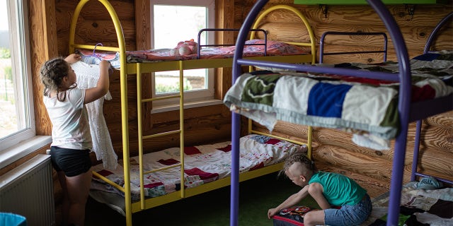 KYIV, UKRAINE - JUNE 20: Children unpack on June 20, 2022 near Kyiv, Ukraine. The goal of the 7fields camp, which is near Zalissia National Nature Park, is to support the children of families displaced from other parts of Ukraine since the February 24 invasion, but who are remaining in the country. Over the summer, the camp aims to support 300 children between the ages of 7 and 15, with activities like swimming pools, tennis, soccer, yoga, chess and craft-making, in addition to therapy sessions. (Photo by Alexey Furman/Getty Images)