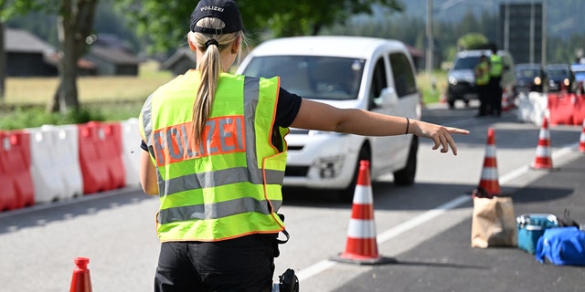 Bavarian police officers control traffic across the Mittenwald border as part of the G7 Summit. 