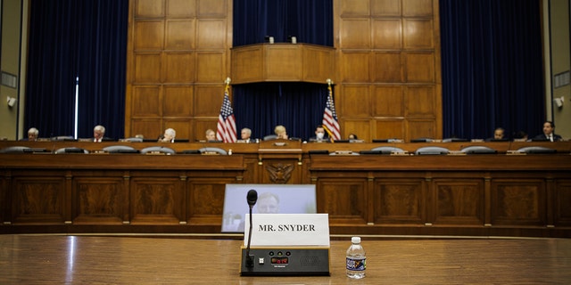 An empty seat marked for Dan Snyder, owner of the Washington Commanders football team, as RogerGoodel, commissioner of the National Football League (NFL), center, speaks via videoconference during a House Oversight and Reform Committee hearing in Washington, D.C., US, on Wednesday, June 22, 2022. 