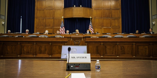 An empty seat marked for Dan Snyder, owner of the Washington Commanders football team, as RogerGoodel, commissioner of the National Football League (NFL), center, speaks via videoconference during a House Oversight and Reform Committee hearing in Washington, D.C., US, on Wednesday, June 22, 2022.