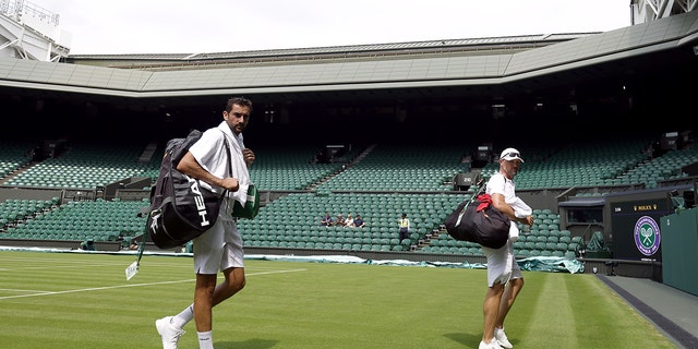 Marin Cilic leaves the court after practicing on center court ahead of the 2022 Wimbledon Championships at the All England Lawn Tennis and Croquet Club, Wimbledon.  Cilic was the first player to withdraw after testing positive for COVID-19. 