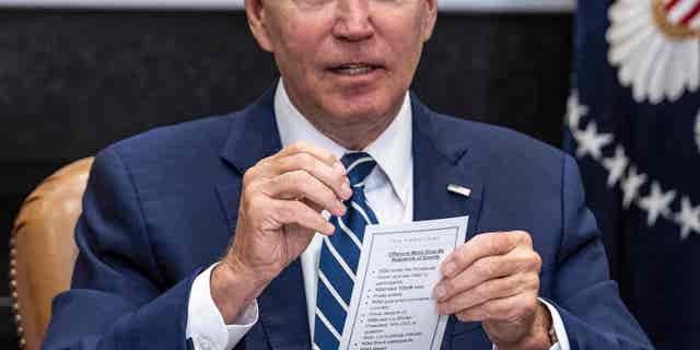 US President Joe Biden speaks from his notes with governors, labor leaders, and private companies launching the Federal-State Offshore Wind Implementation Partnership as he drops by a meeting at the White House in Washington, DC, on June 23, 2022. (Photo by Jim WATSON / AFP) (Photo by JIM WATSON/AFP via Getty Images)