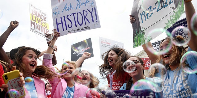 Anti-abortion campaigners celebrate outside the Supreme Court in Washington, D.C., on June 24, 2022.