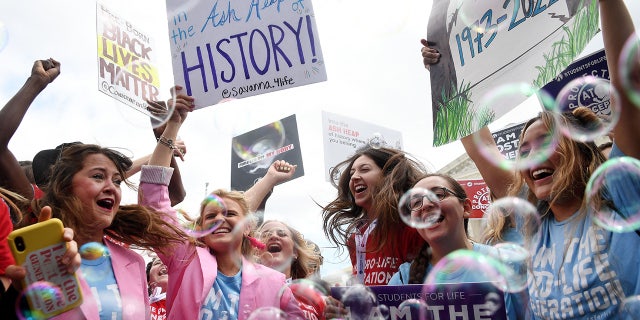 Anti-abortion campaigners celebrate outside the US Supreme Court in Washington, DC, on June 24, 2022.